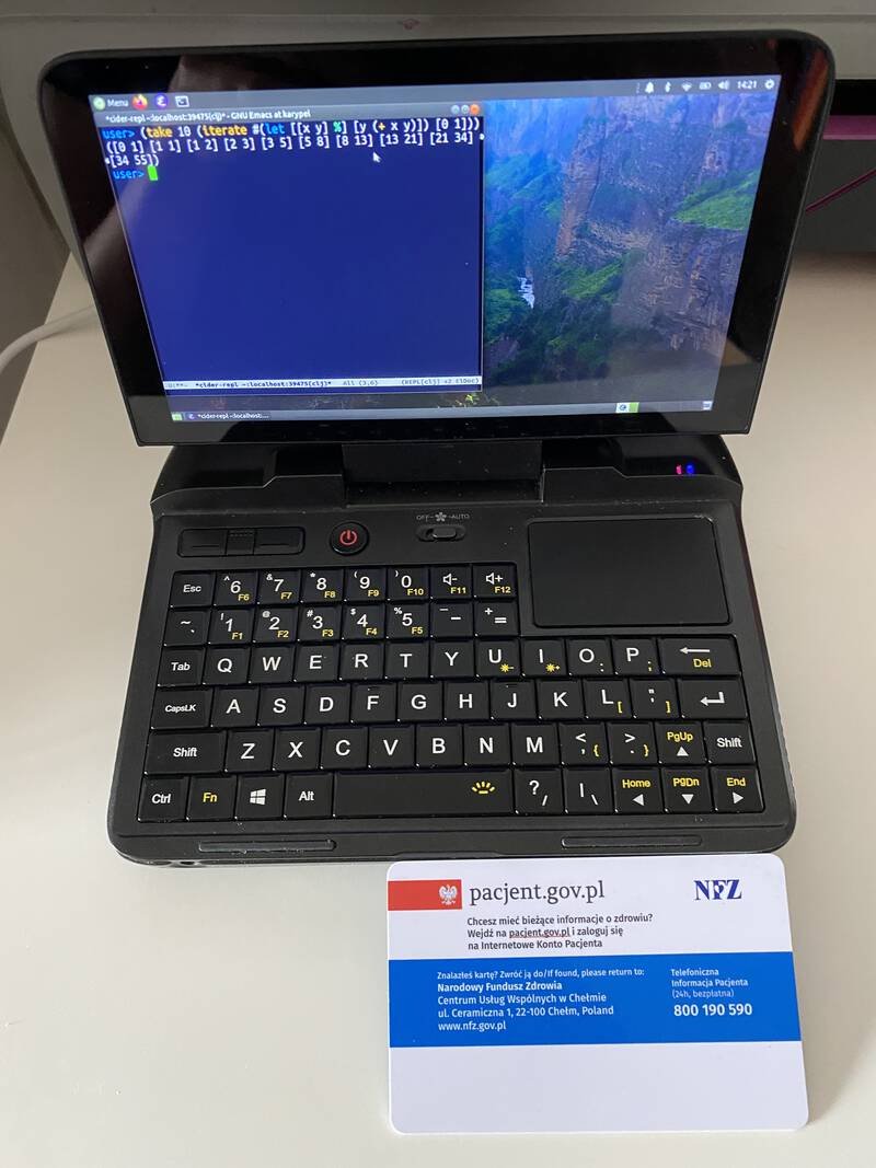 The GPD Micro PC running Emacs on Ubuntu MATE and a credit-size card for scale